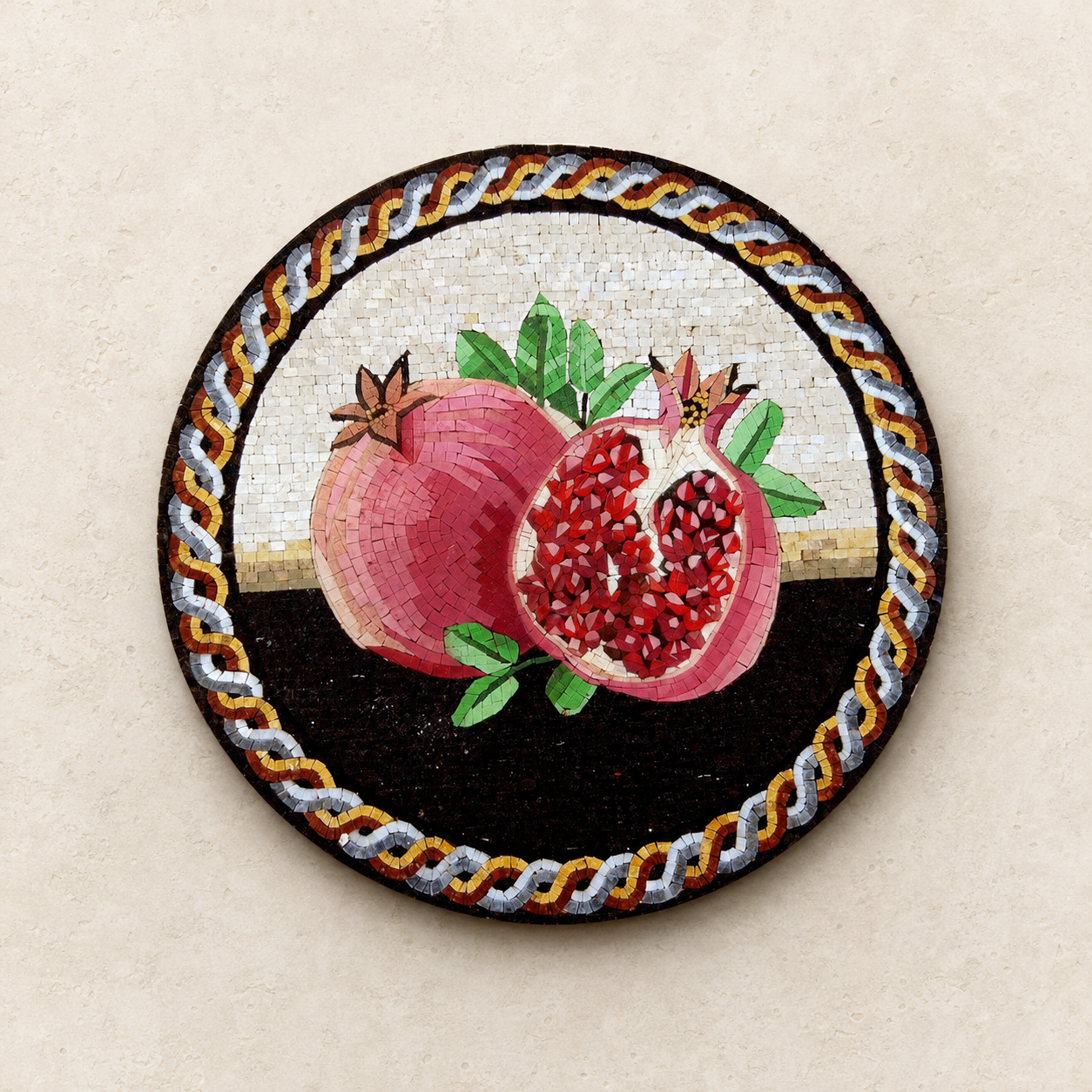 Round mosaic medallion of pomegranates made from individual stone tesserae, showing the detail of each small piece